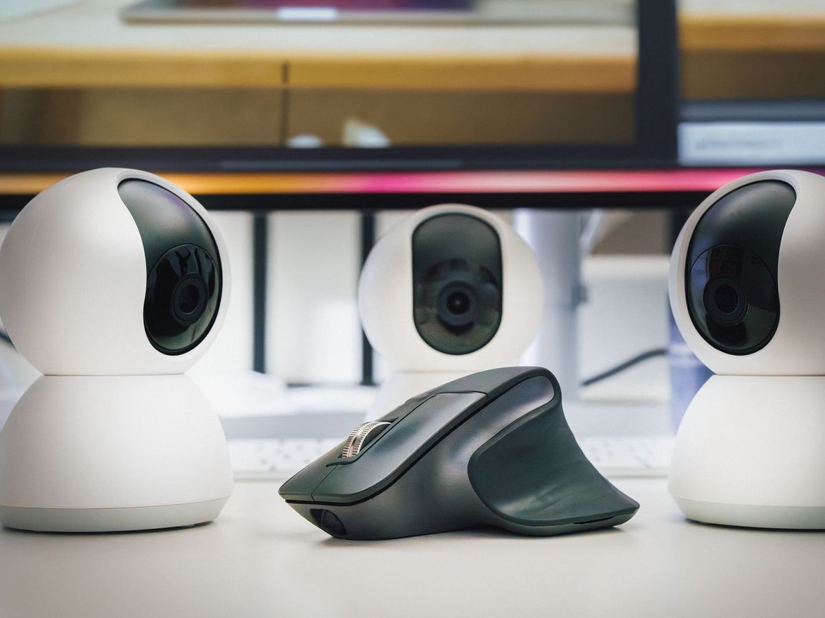 Trois webcams blanches disposées sur un bureau